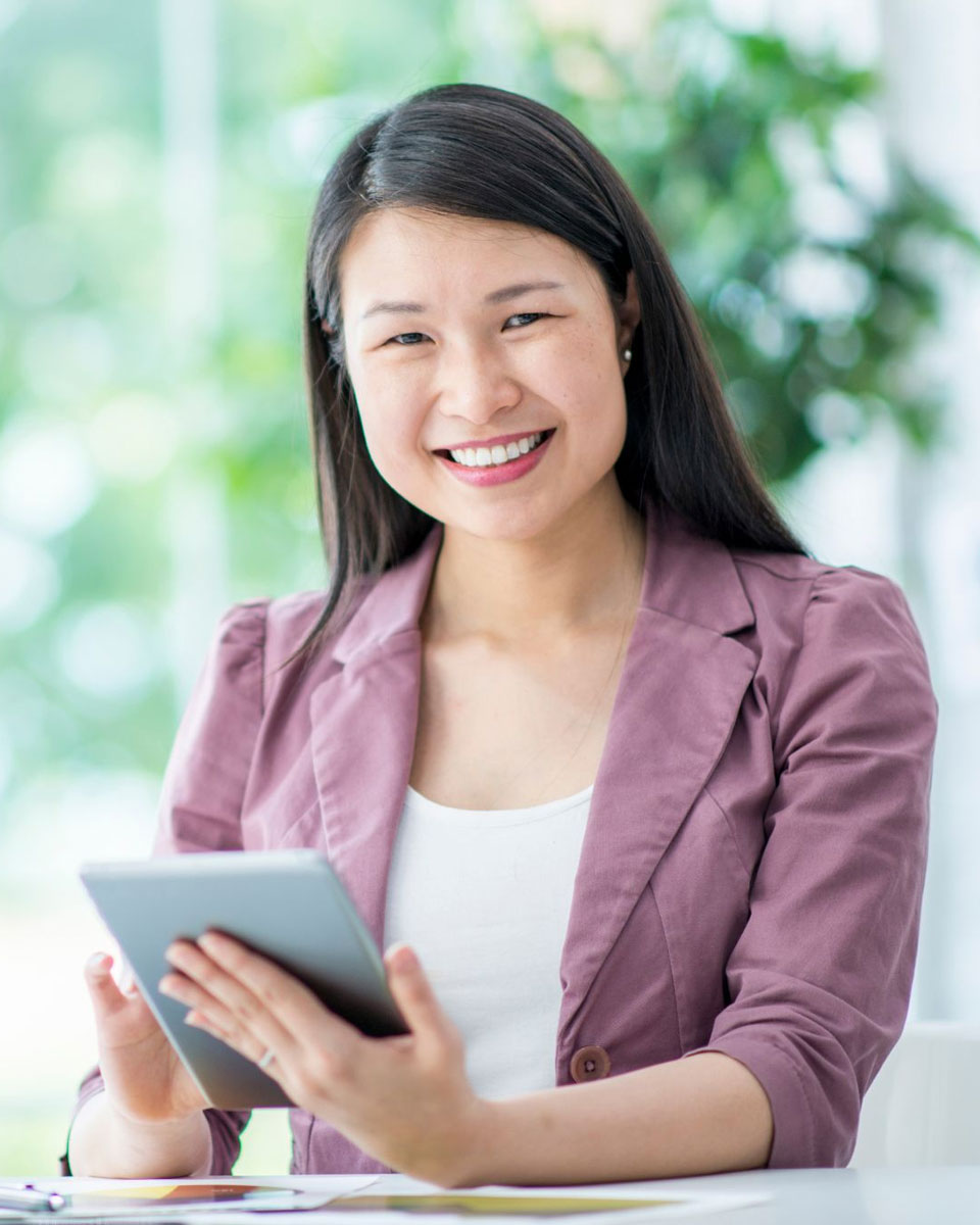 Smiling woman holding mobile device
